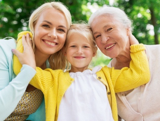 Young girl smiling with her mother and grandmother