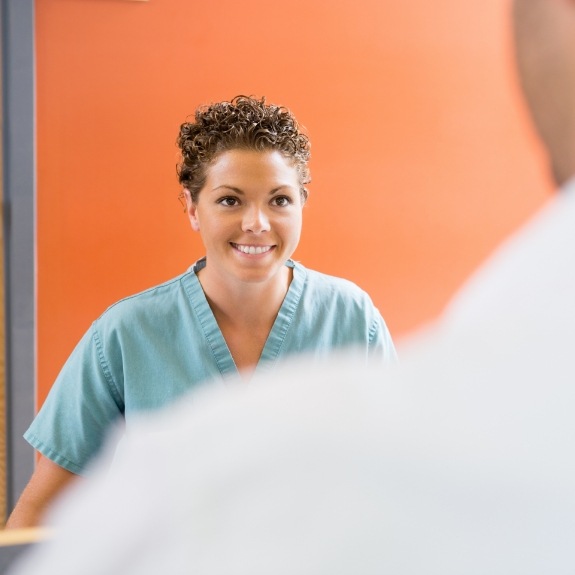 Dental team member smiling at patient