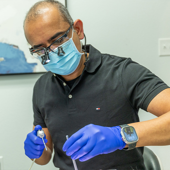 Doctor Ahir performing a dental checkup on a patient in Denton