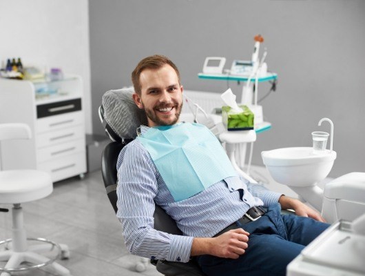 Smiling man sitting in dental chair