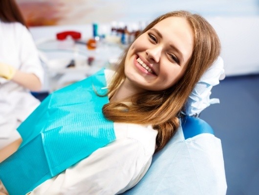 Young woman grinning in dental chair