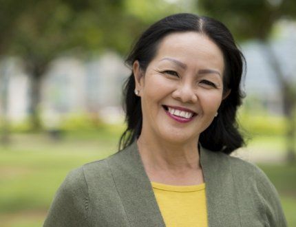 Woman in dark green jacket grinning