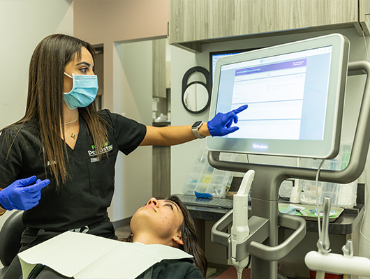 Dental team member touching computer screen