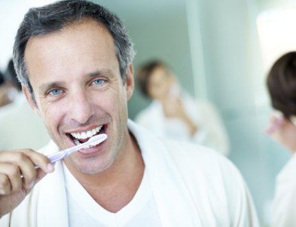 Older man brushing his teeth