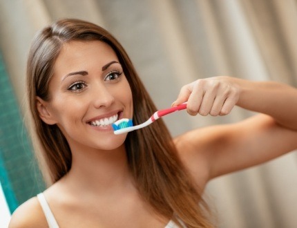 Young woman brushing her teeth