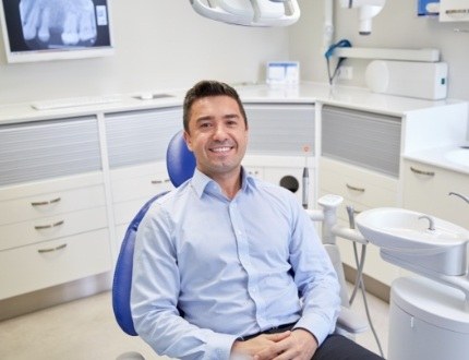 Smiling man sitting in dental chair