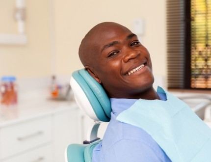 Smiling man leaning back in dental chair