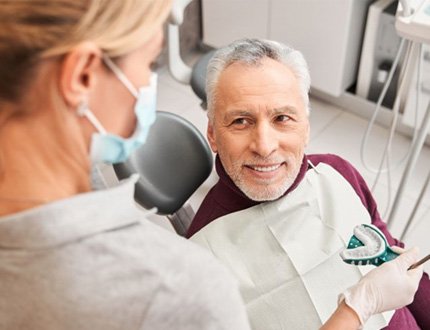 Mature man getting dental impression taken