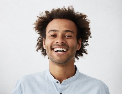 Smiling man in light blue shirt