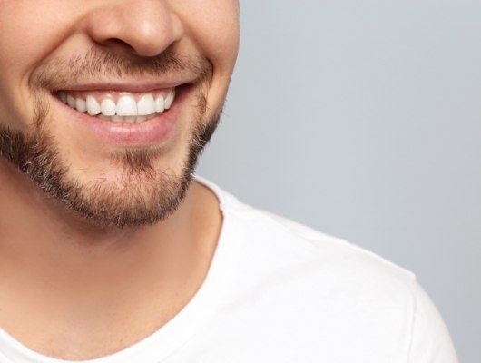 Close up of smiling man with short beard