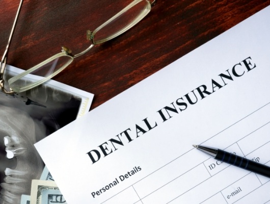 Dental insurance form on dark wood table