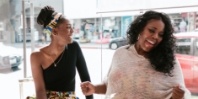 Two smiling women at dental office front desk