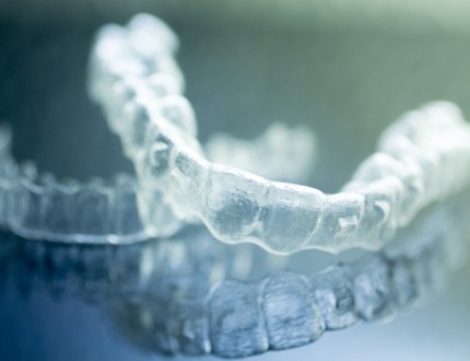 Two clear aligners resting on table