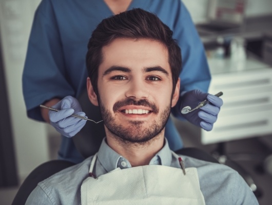 Man with short beard sitting in dental chair