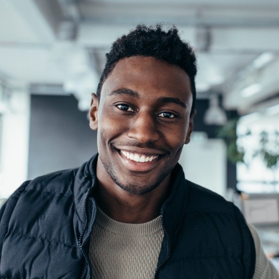 Smiling man standing in an office