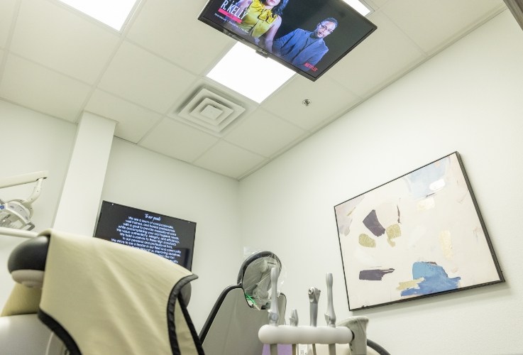 Dental treatment room with T V on ceiling