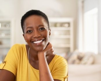 Smiling woman in yellow blouse