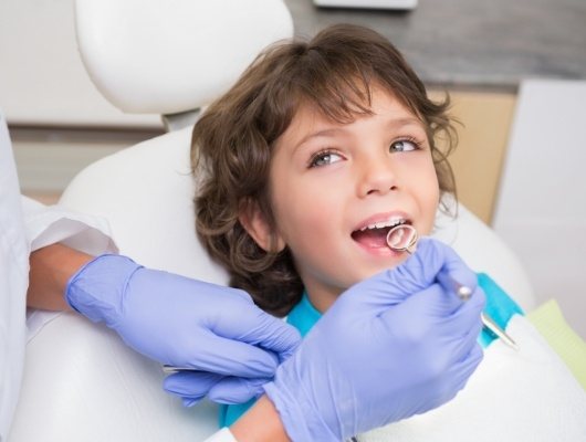 Child smiling during dental exam