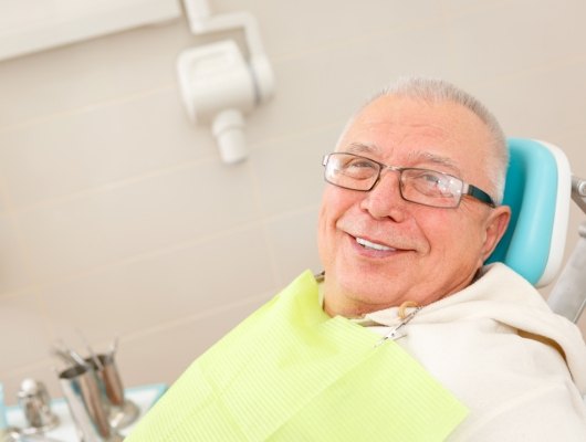Senior man smiling in dental chair