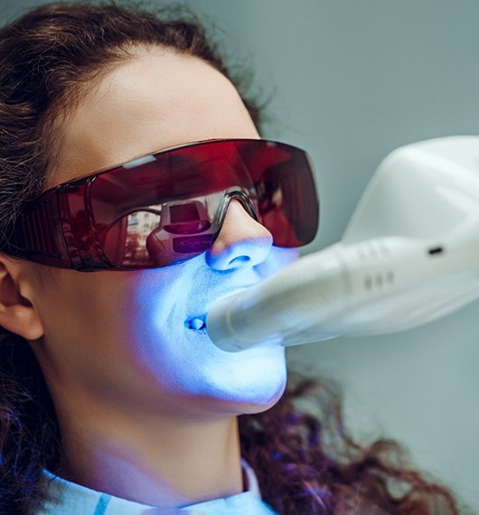 Woman having in-office whitening treatment