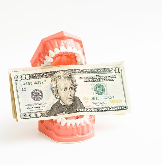 Money in a set of model teeth