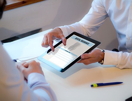 An insurance agent discussing dental insurance with a patient