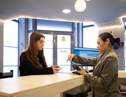 A young woman paying for her dental care