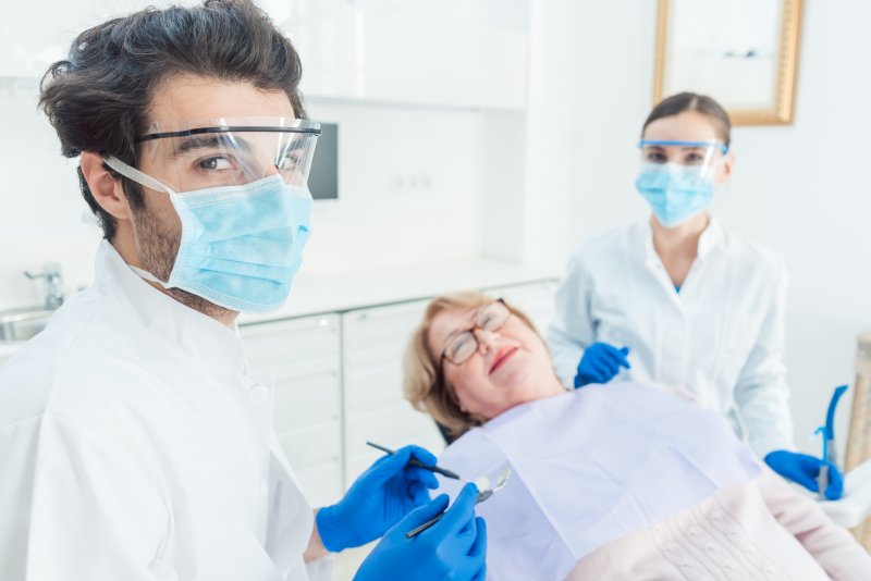 Dental team wearing PPE with patient