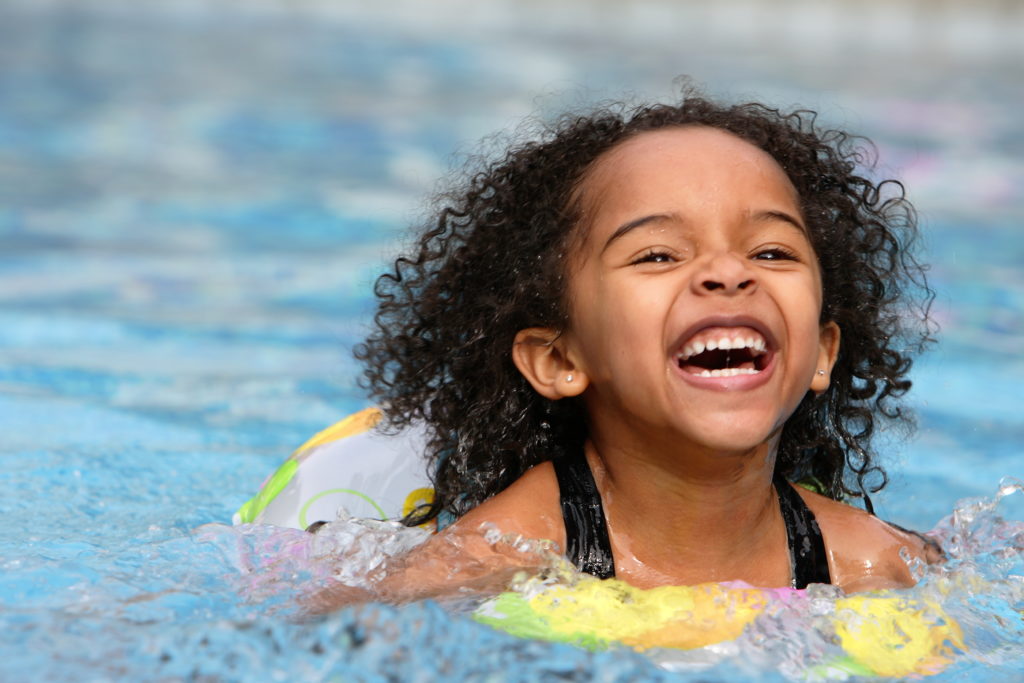 child swimming during summer