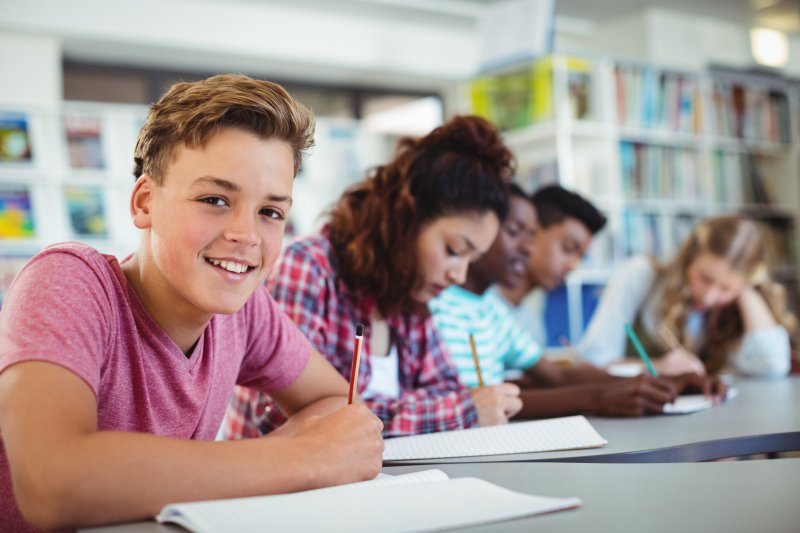 Invisalign teen in school library