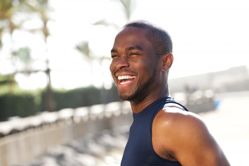 man smiling while exercising before visiting Denton dentist