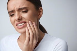 Woman experiencing a severe toothache. 