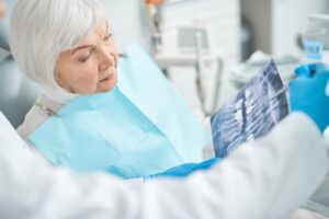 elderly patient looking at an X-ray during an implant consultation
