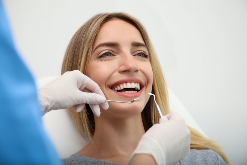 A smiling woman being assessed for cosmetic dentistry
